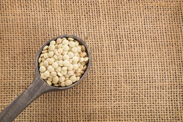 Lentils on wooden surface (Lens culinaris) — Stock Photo, Image