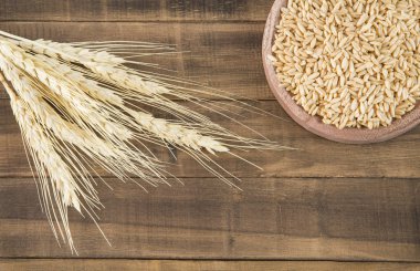 Doğal ahşap arka plan (Avena sativa Kupası'nda yulaf taneli pirinç)