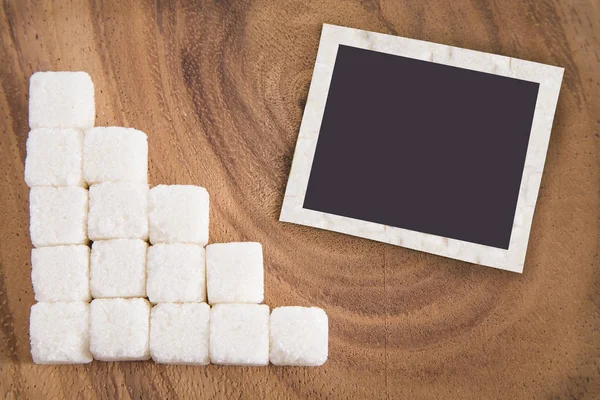 Cubetti di zucchero bianco sulla superficie di legno — Foto Stock