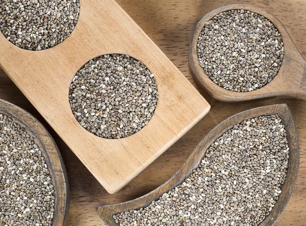 Chia seeds in the wooden bowl - Salvia hispanica