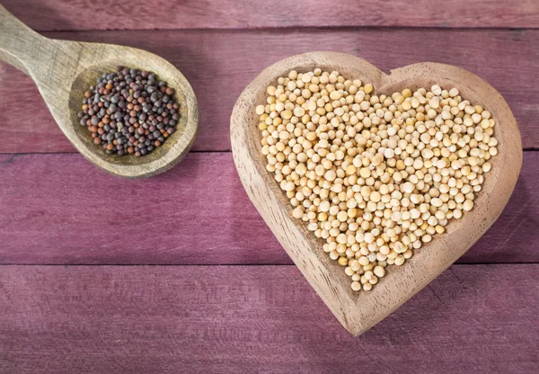 Seeds of yellow and black mustard — Stock Photo, Image