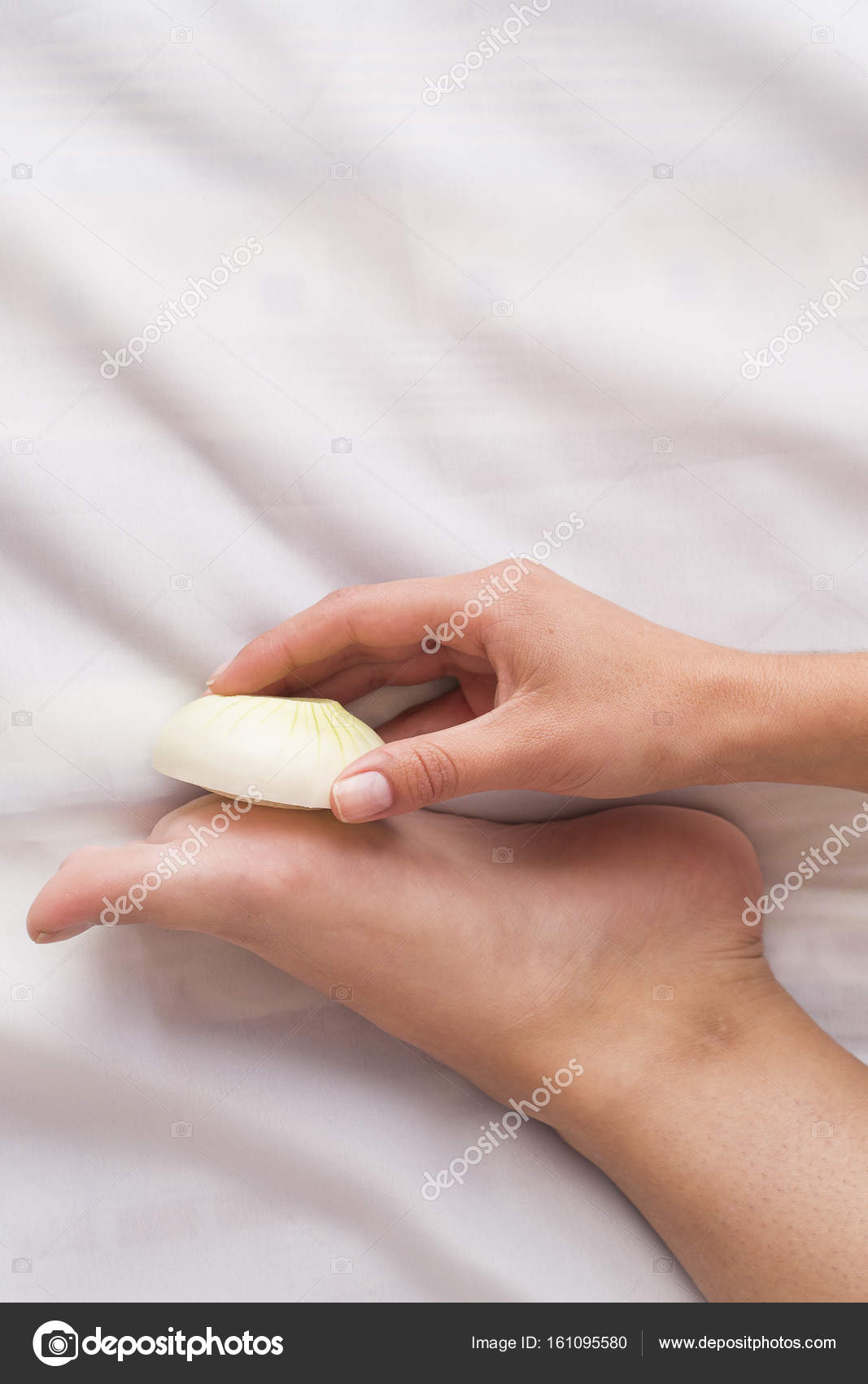 Onion slices in the foot as a medical treatment Stock Photo by ©Luisecheverriurrea 161095580