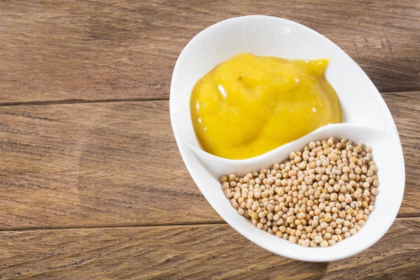 Sauce and seeds of yellow mustard - Sinapis alba Stock Image