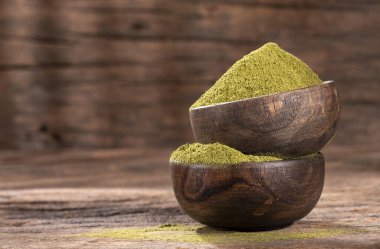 Moringa oleifera - Organic moringa powder in wooden bowls clipart
