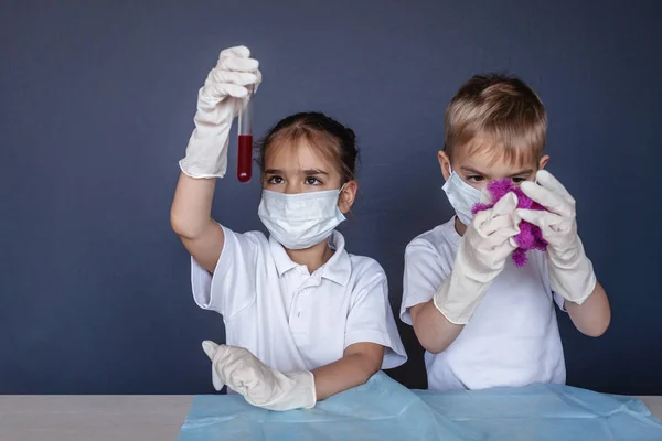 Criança bonito usando máscara respiradora e luvas de medicina segurando um b — Fotografia de Stock