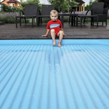 Automatic swimming pool covering system, safely protect children and pets from accidental contact with water, home and cottage equipment, copyspace, place for text, outdoor exterior clipart