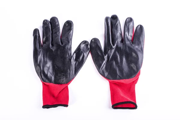 Ropa de trabajo, protección para las manos guantes rojos y negros para trabajo industrial . Fotos De Stock Sin Royalties Gratis