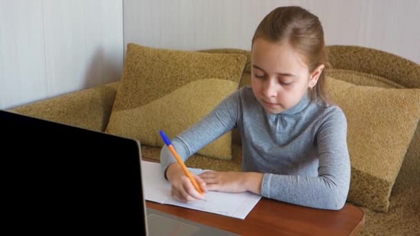 Afstandsonderwijs concept, on-line onderwijs thuis. Schoolmeisje video chatten met een leraar thuis tijdens de coronavirus epidemie in de stad. — Stockvideo