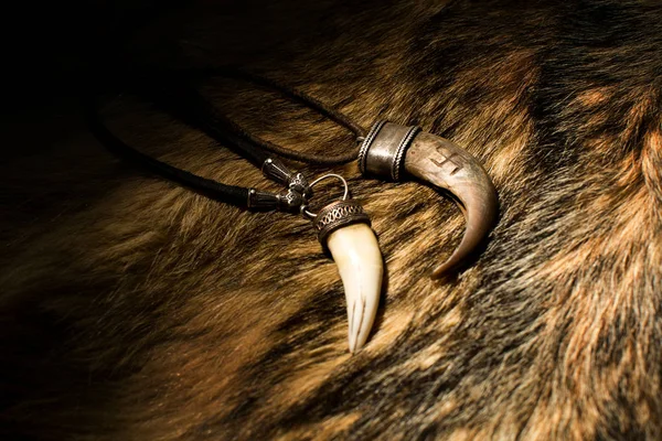 Carved tusk pendant of bone — Stock Photo, Image