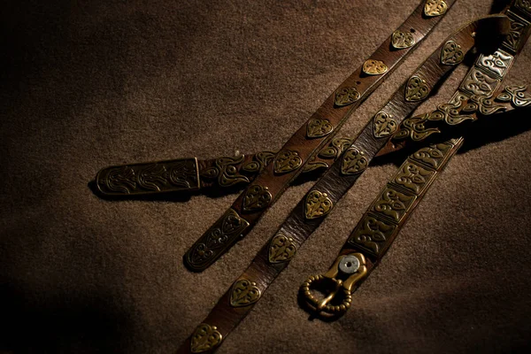 Leather belts with decoration of metal isolated on dark backgrou — Stock Photo, Image