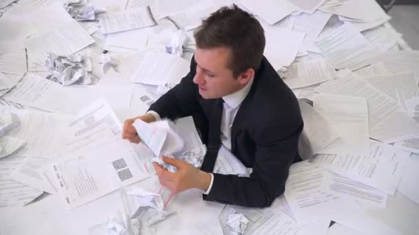 The man in the office drowning in paper — Stock Footage The man in the office drowning in paper Royalty Free Stock Video