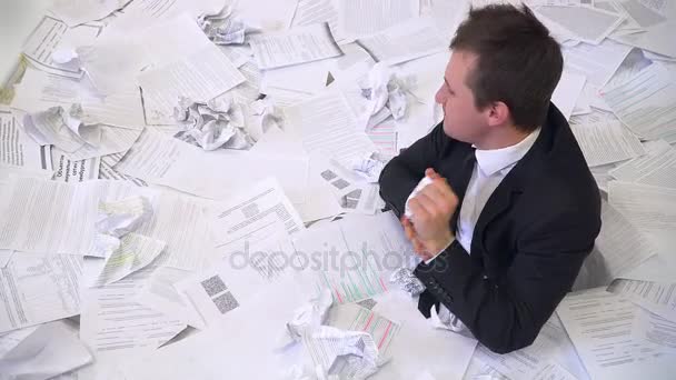 The man in the office drowning in paper — Stock Footage The man in the office drowning in paper Stock Footage