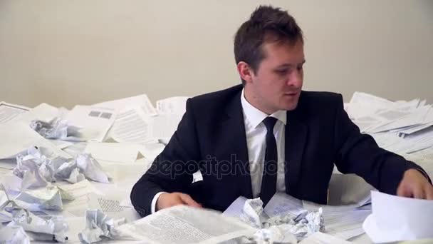The man in the office drowning in paper — Stock Footage The man in the office drowning in paper Royalty Free Stock Video