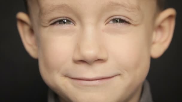 Portrait of a boy close-up on a black background. Full hd video — Stock Video