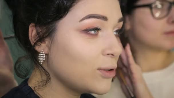 Visagist zetten make-up op de ogen van de modellen. — Stockvideo
