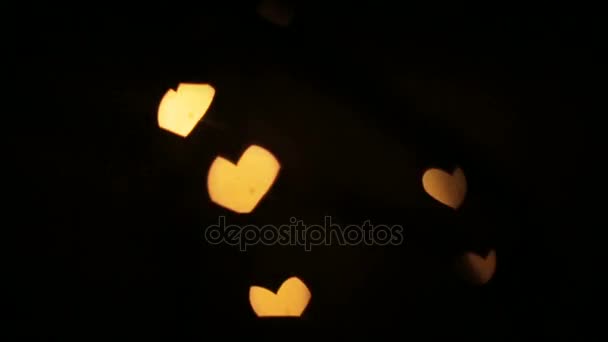 Illumination garland decoration blinking on heart shaped bokeh background. — Stock Video