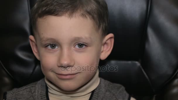 Serious boy in office on armchair, close-up — Stock Video