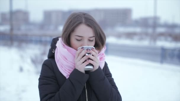 Woman drinking cappuccino coffee from a paper cup — Stock Video