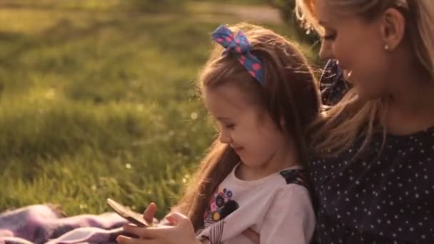 Glückliche Familie, Mutter und Tochter spielen auf der Wiese — Stockvideo