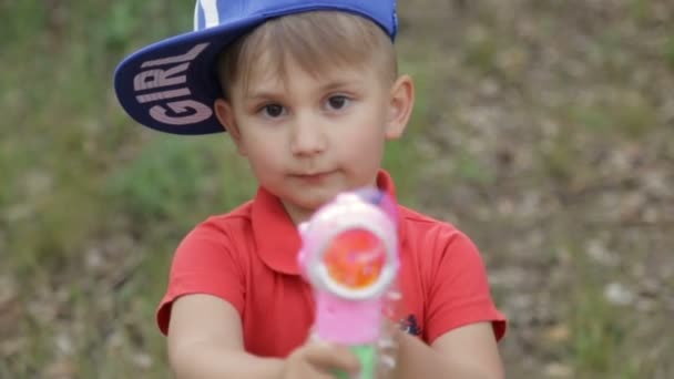 The boy plays with soap bubbles — Stock Video