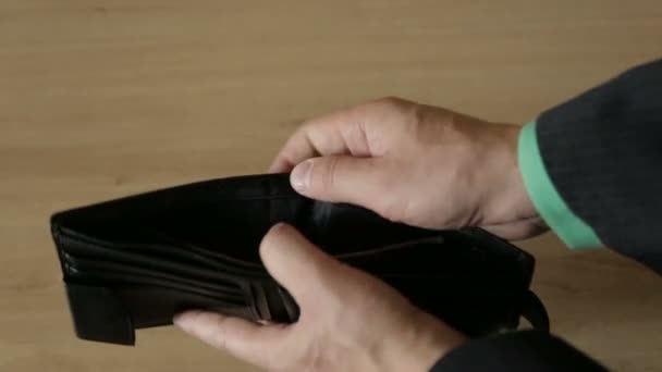 Een man haalt bankbiljetten van een lederen tas — Stockvideo