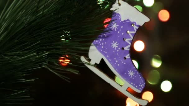 Christmas wooden toy on the Christmas tree. Christmas Eco Toy Skates — Stock Video