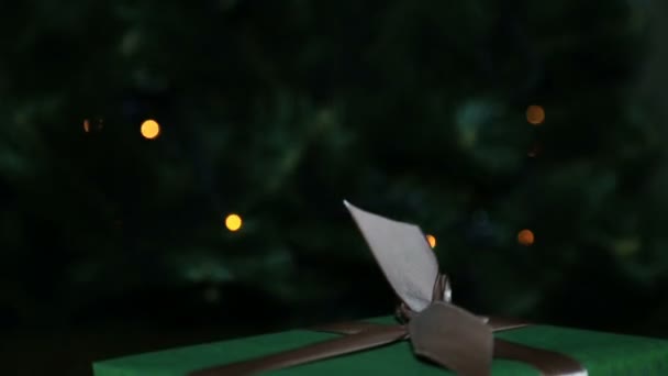 De gift van Kerstmis in een vak dat is gebonden met een bruin lint met een strik — Stockvideo