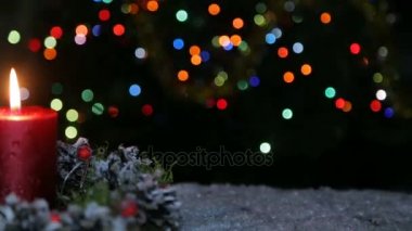 Bir mum ve bir bokeh arka planda bir hediye kutusu