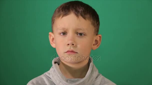 Child portrait, boy looks at the camera — Stock Video