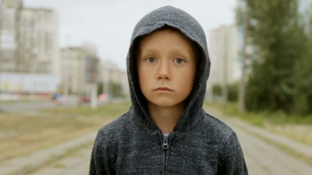 A boy in a black hood on the street — Stock Video