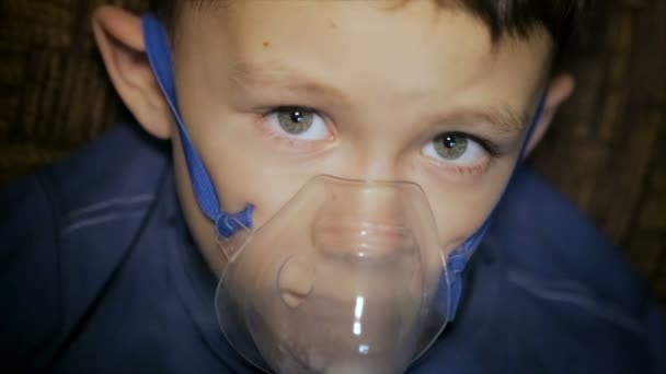 The boy is breathing through the inhaler — Stock Video