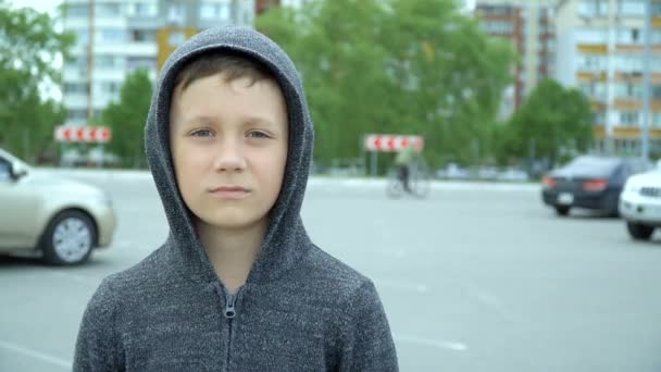 Chlapec v černé kápi na ulici — Stock video
