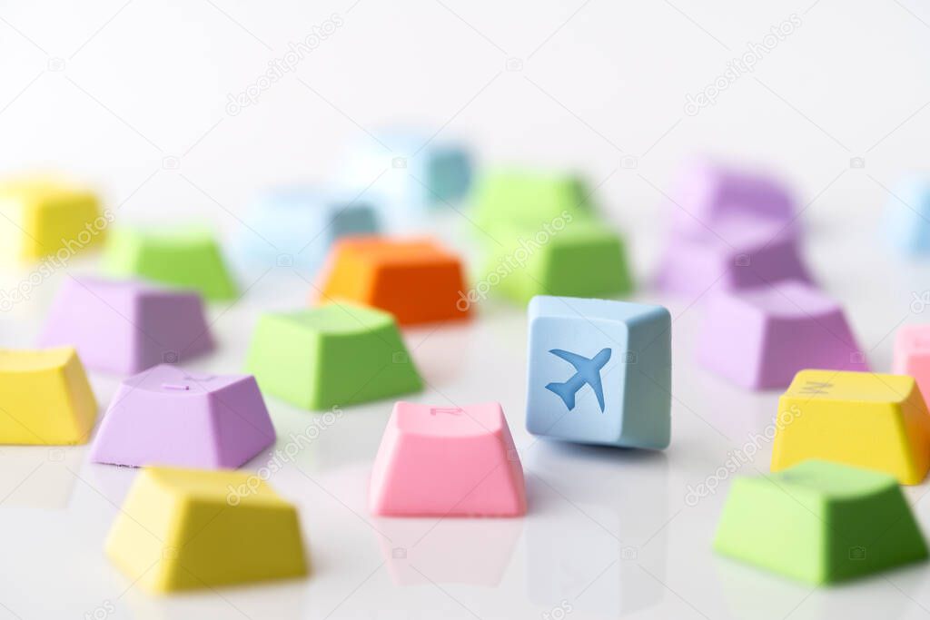 Colorful travel icon on computer keyboard for online booking con