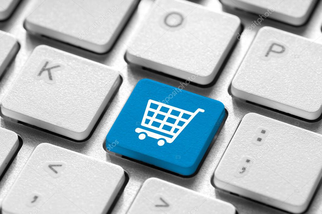 Online shopping & business icon on white computer keyboard