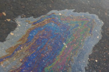 Asfalt üzerinden ıslak yolda petrol ürünleri uzakta büyük bir çok renkli nokta, yatay fotoğraf ile sünme dökülen