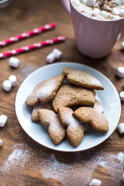 Spicy ginger cookies covered with powdered sugar on window sill — Stock Photo, Image