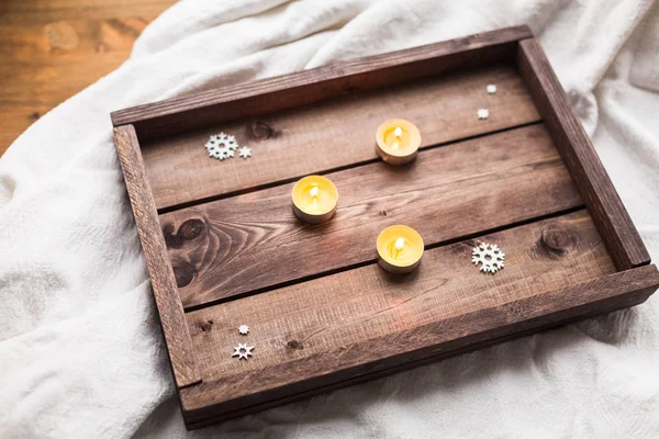 Candles at Christmas tray om window — Stock Photo, Image