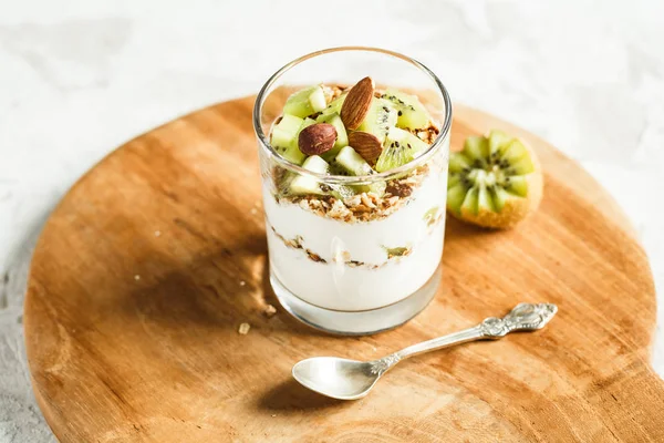 Sklo jogurt s müsli a kiwi řezy. Snídaně koncept — Stock fotografie