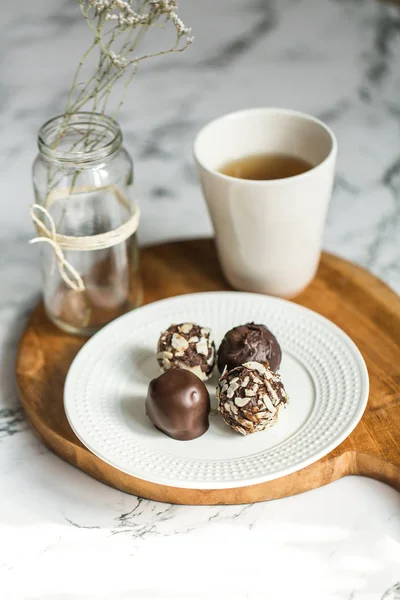 Useful sweets with coconut in chocolate and tea