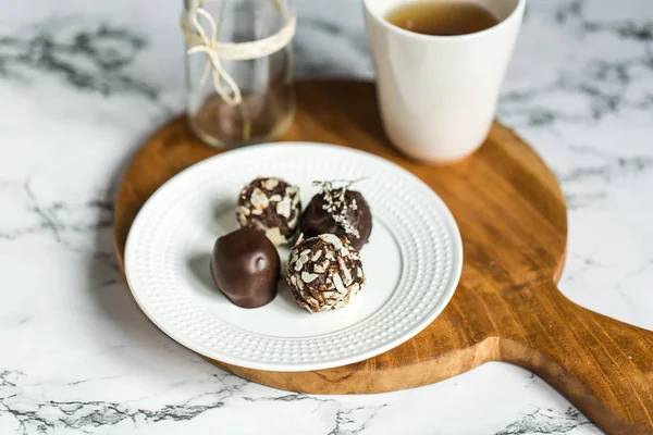 Useful sweets with coconut in chocolate and tea