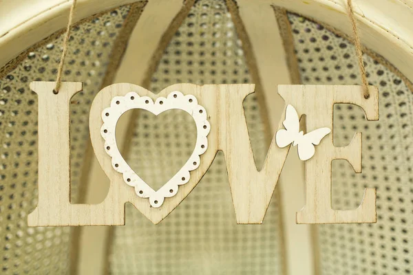 Wooden inscription love on the wall — Stock Photo, Image