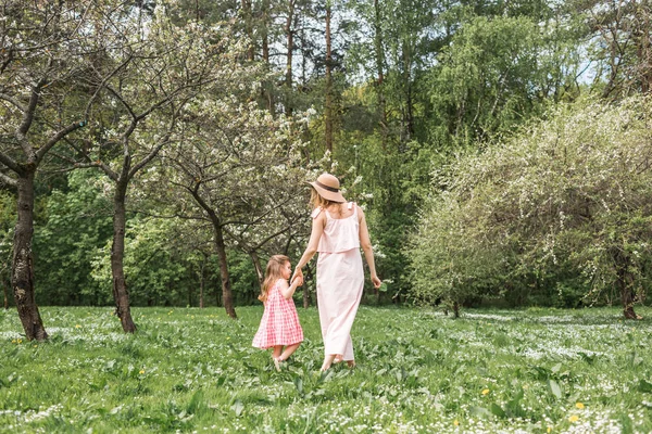 ママと娘は庭で歩いています。 — ストック写真