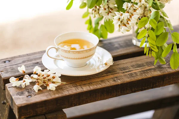 A cup of tea and a saucer on veranda — Stock Photo, Image