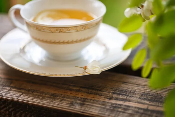 A cup of tea and a saucer on veranda — Stock Photo, Image