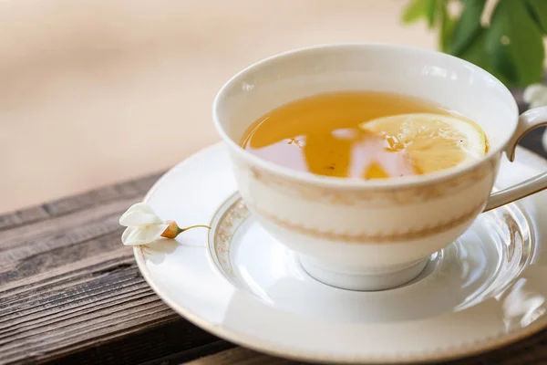 A cup of tea and a saucer on veranda — Stock Photo, Image