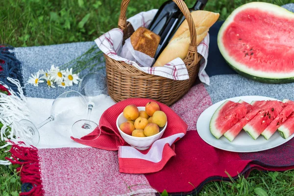 Summer picnic with French bread, wine and watermelon