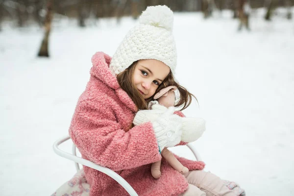 Little girl on sleigh in the forest — Stock Photo, Image
