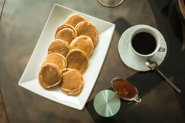 Pancakes on white plate with strawberry jam — Stock Photo, Image