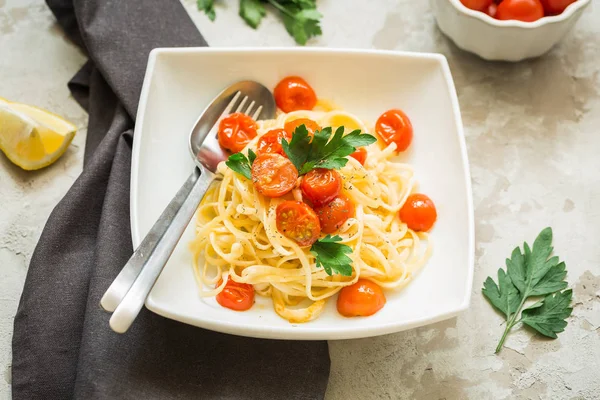 Pasta with tomatoes cherry on the kitchen table, top view — Stock Photo, Image