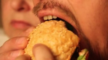 bir erkek ve bir kadın hamburger yeme yakın çekim